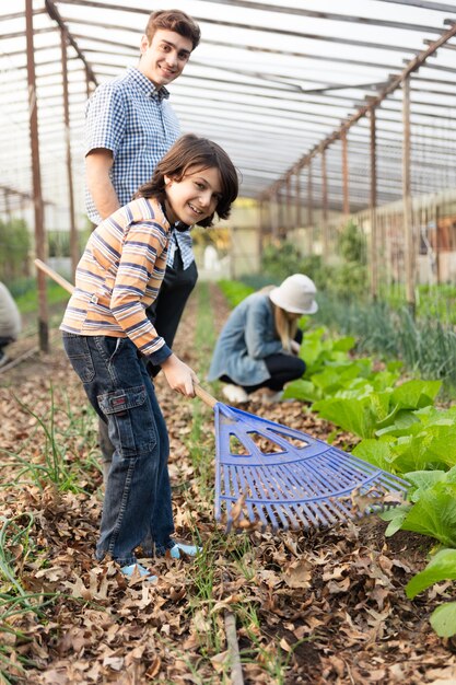 young-gardeners-having-fun-greenhouse_23-2147562168